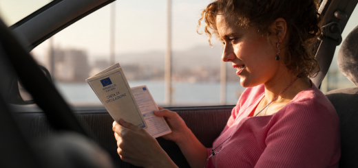 Donna legge la carta di circolazione in auto